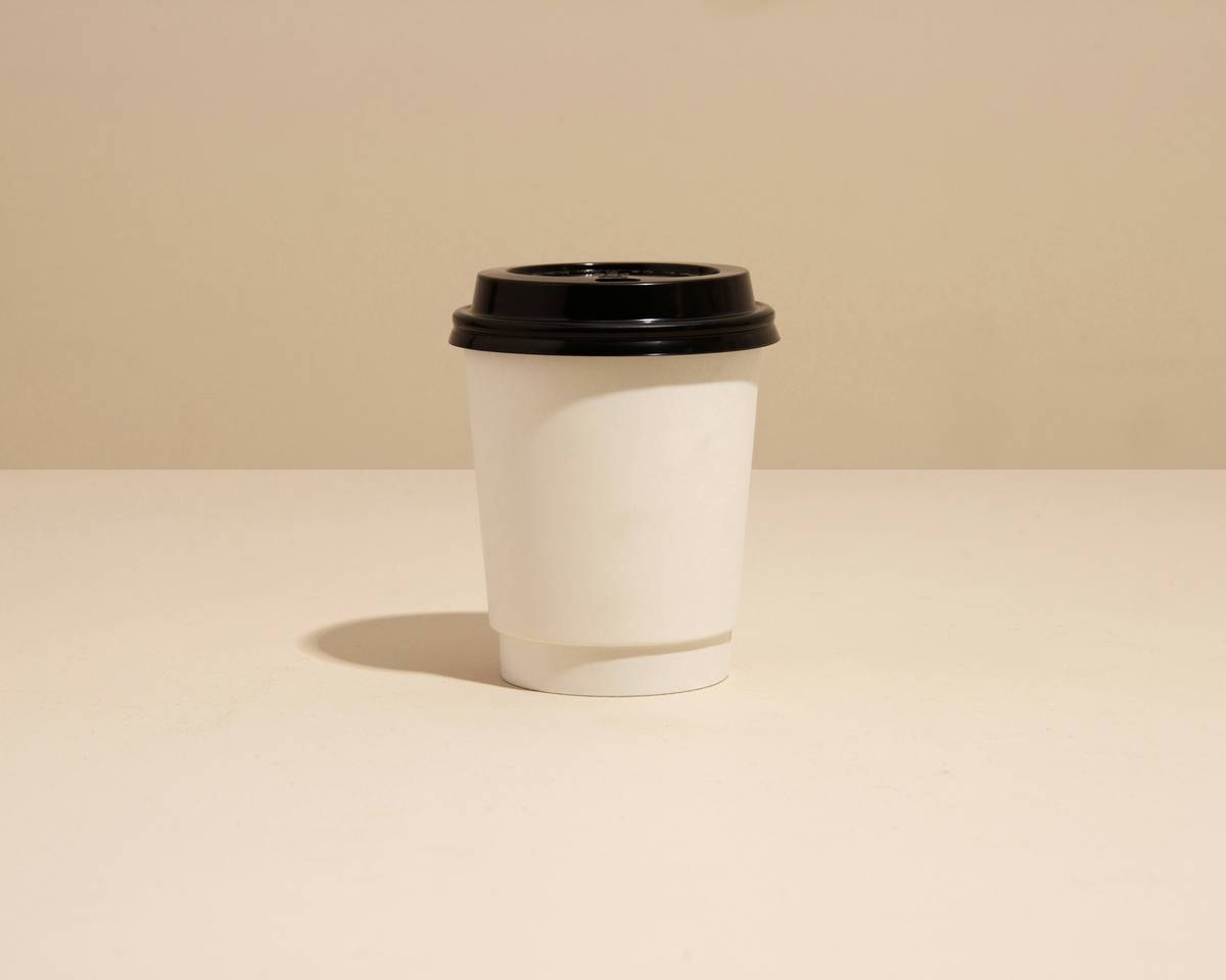 eco friendly option reusable cup lid on ceramic mug with morning coffee
