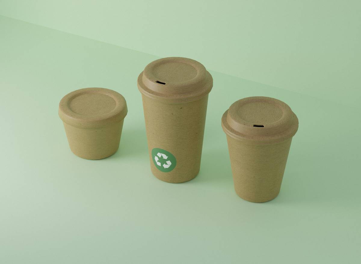 Stackable eco plastic cups with lids in pastel colors on a bamboo kitchen shelf